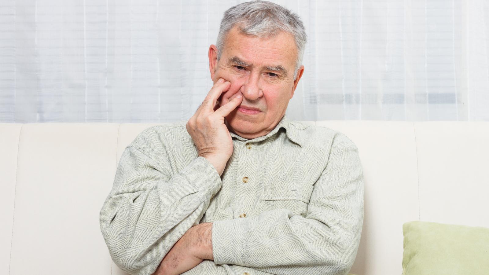 Older man with a sore mouth