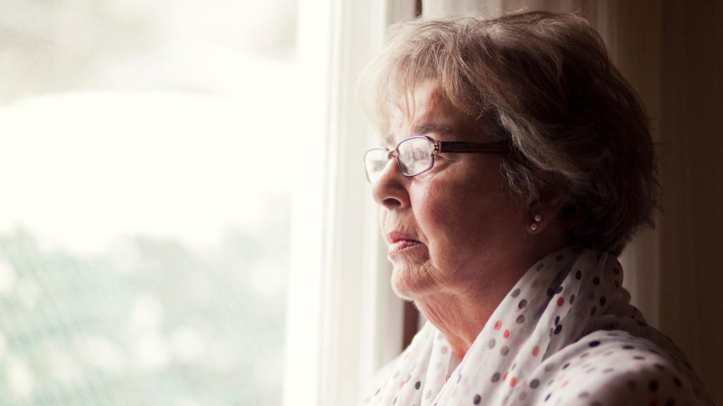 Older woman looking out window