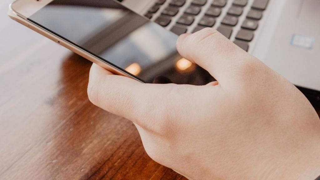 Photo of mobile phone and laptop Photo of mobile phone and laptop
