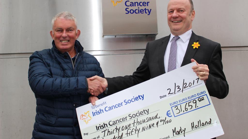 Dr Marty Holland presents the proceeds from the first leg of his Coast for Cancer challenge to Mark Mellett, Head of Fundraising, Irish Cancer Society.